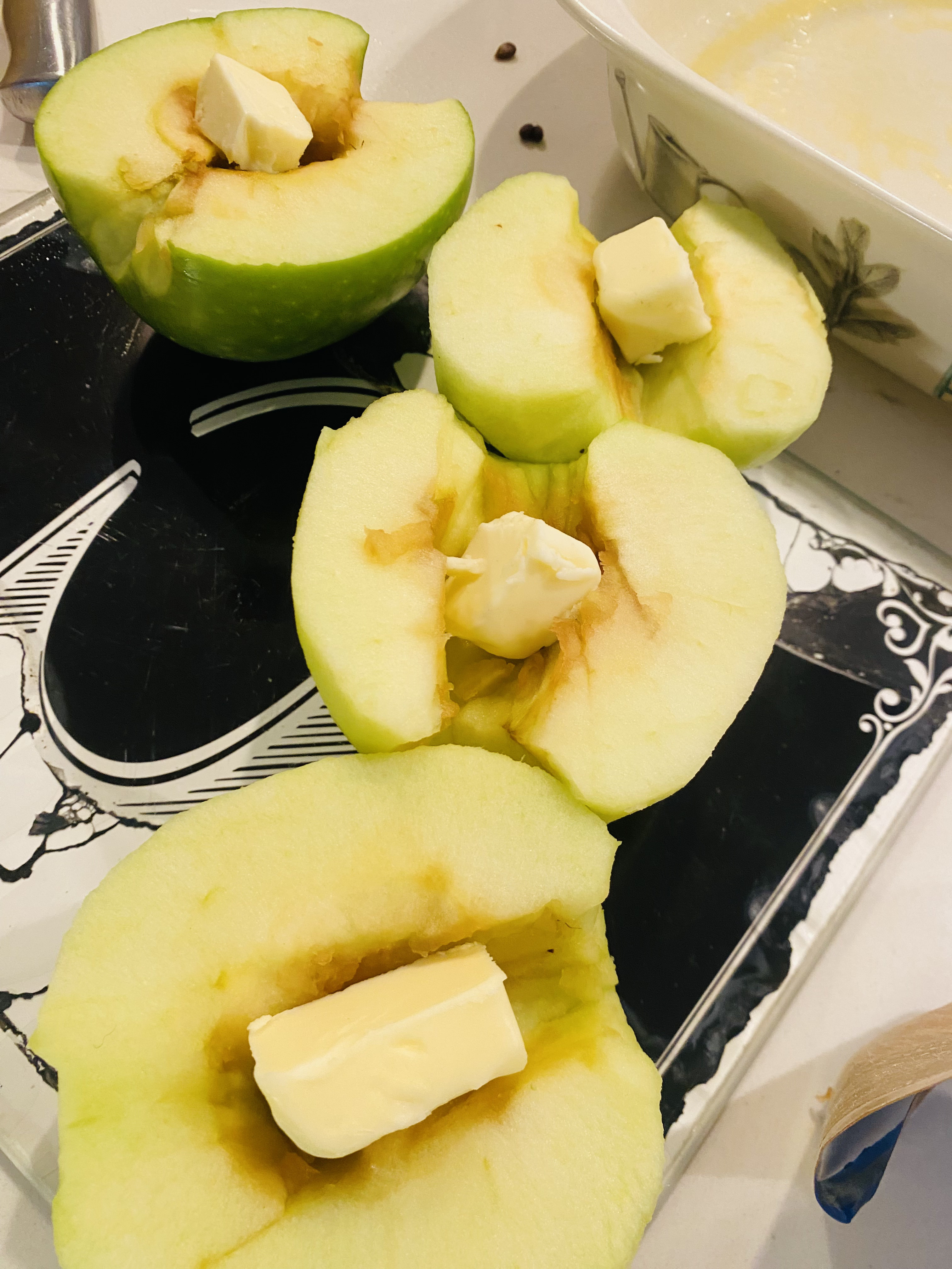 Apples being prepared in a kitchen dish.