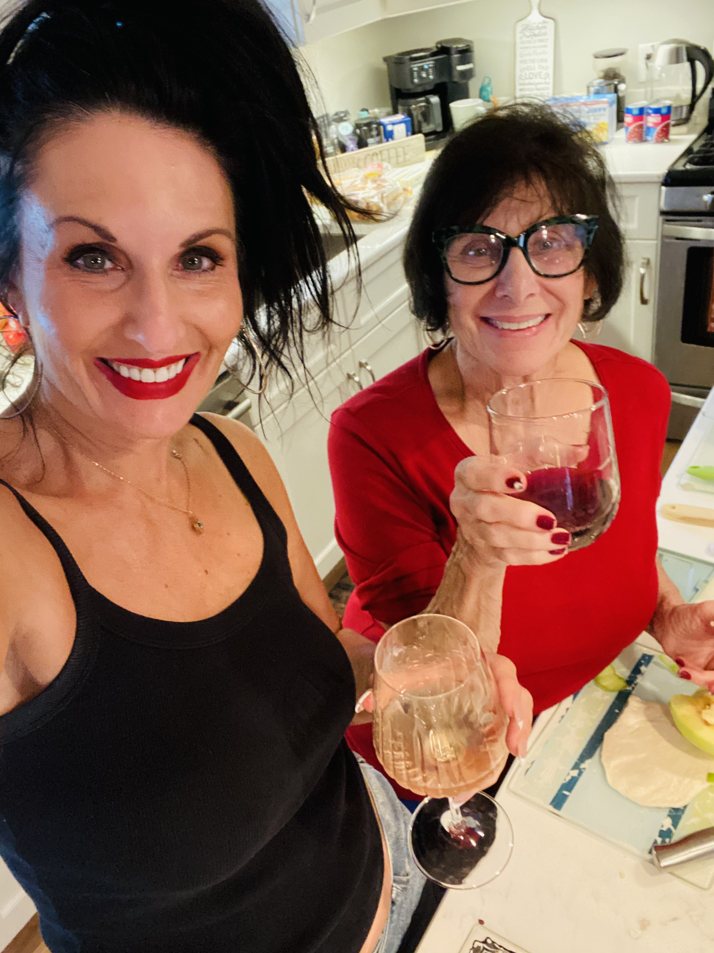 Stacey smiling with her mother in the kitchen.