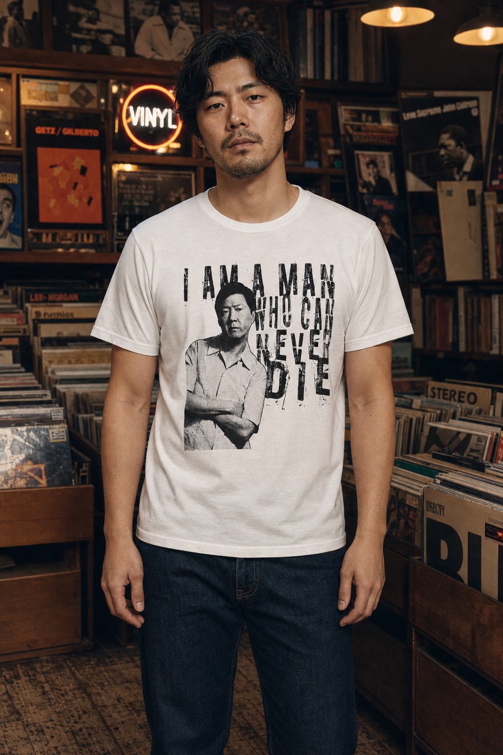 Model wearing the white Community Chang portrait T-shirt with the full artwork visible in a vintage record shop