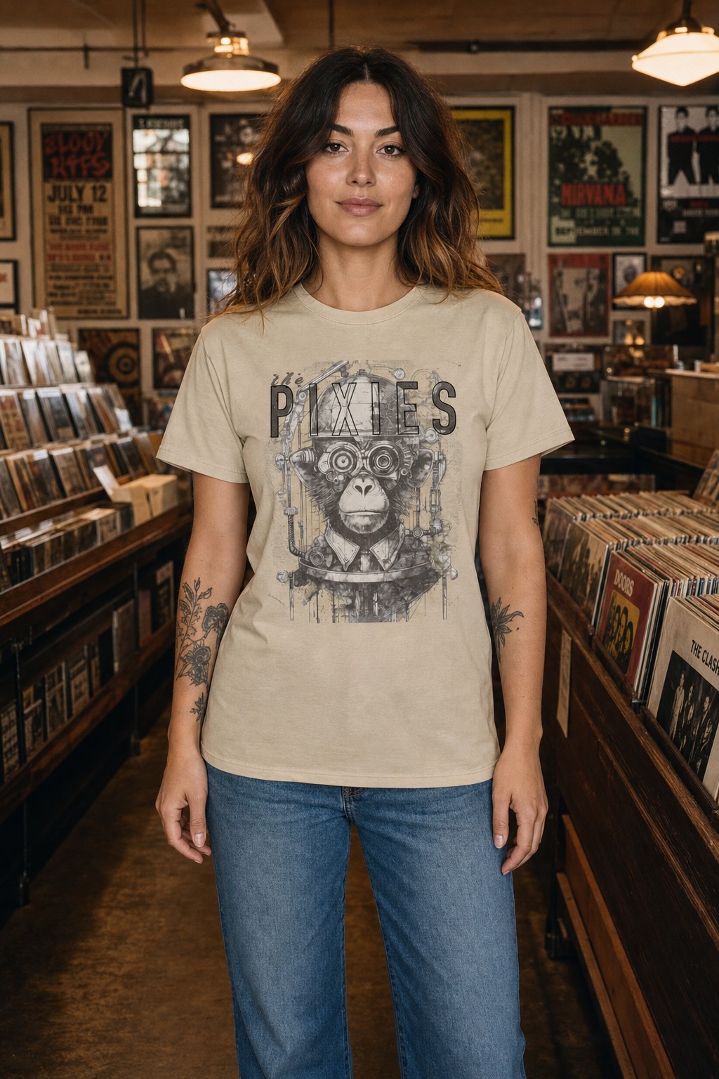 Model wearing the cream Pixies monkey portrait T-shirt with the full artwork visible in a vintage record shop