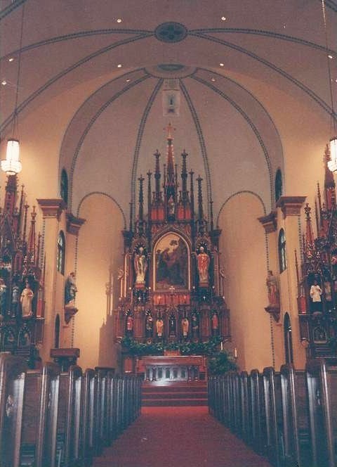 Catholic church interior with a high altar and pews
