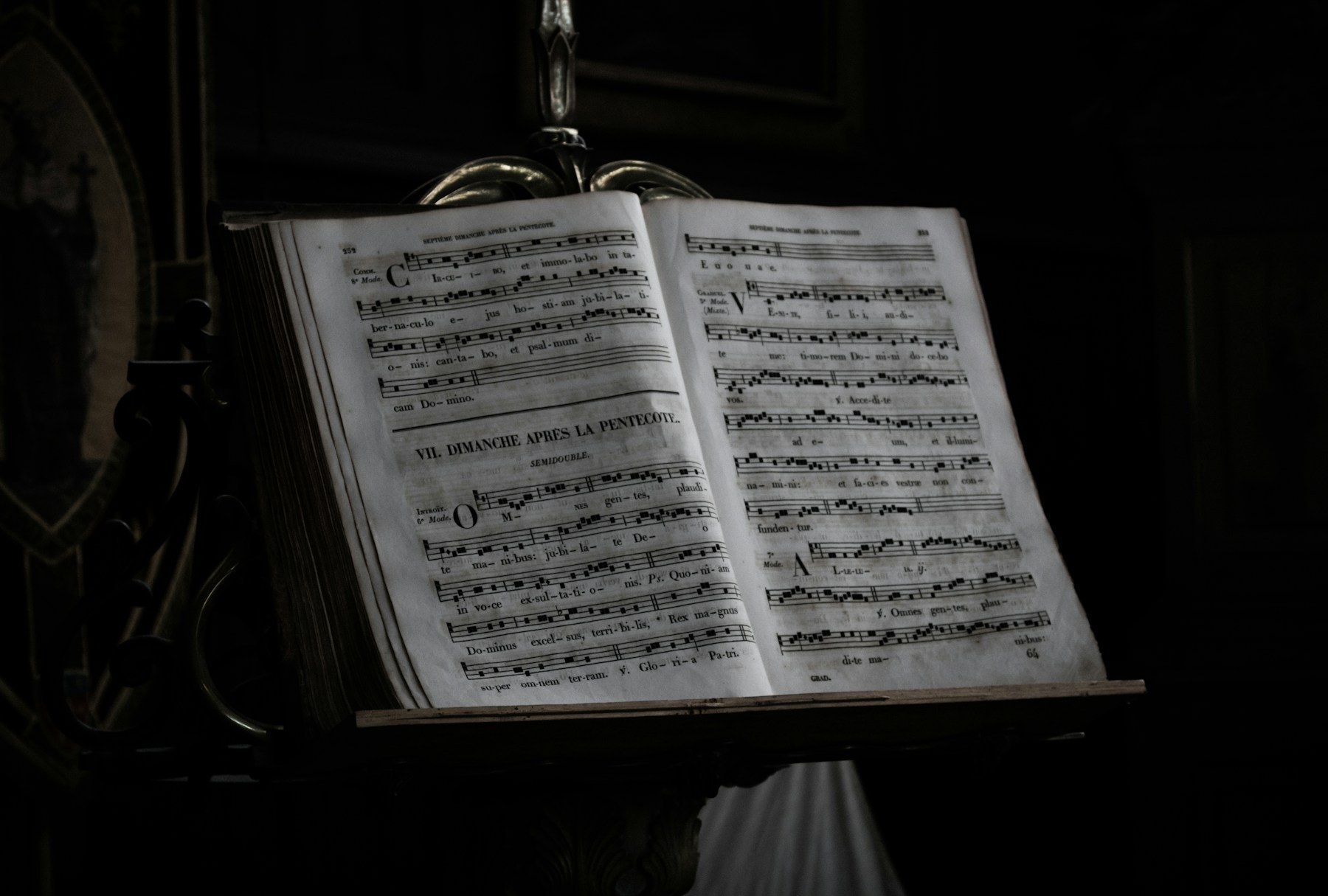 Open Gregorian chant book on a wooden stand