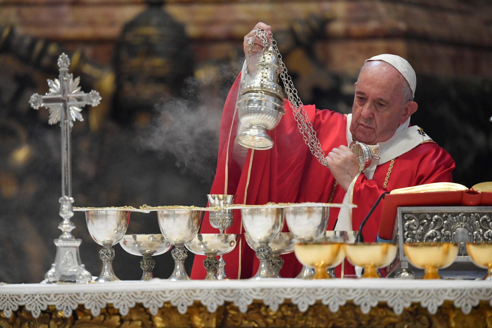 Priest incensing the altar during Mass
