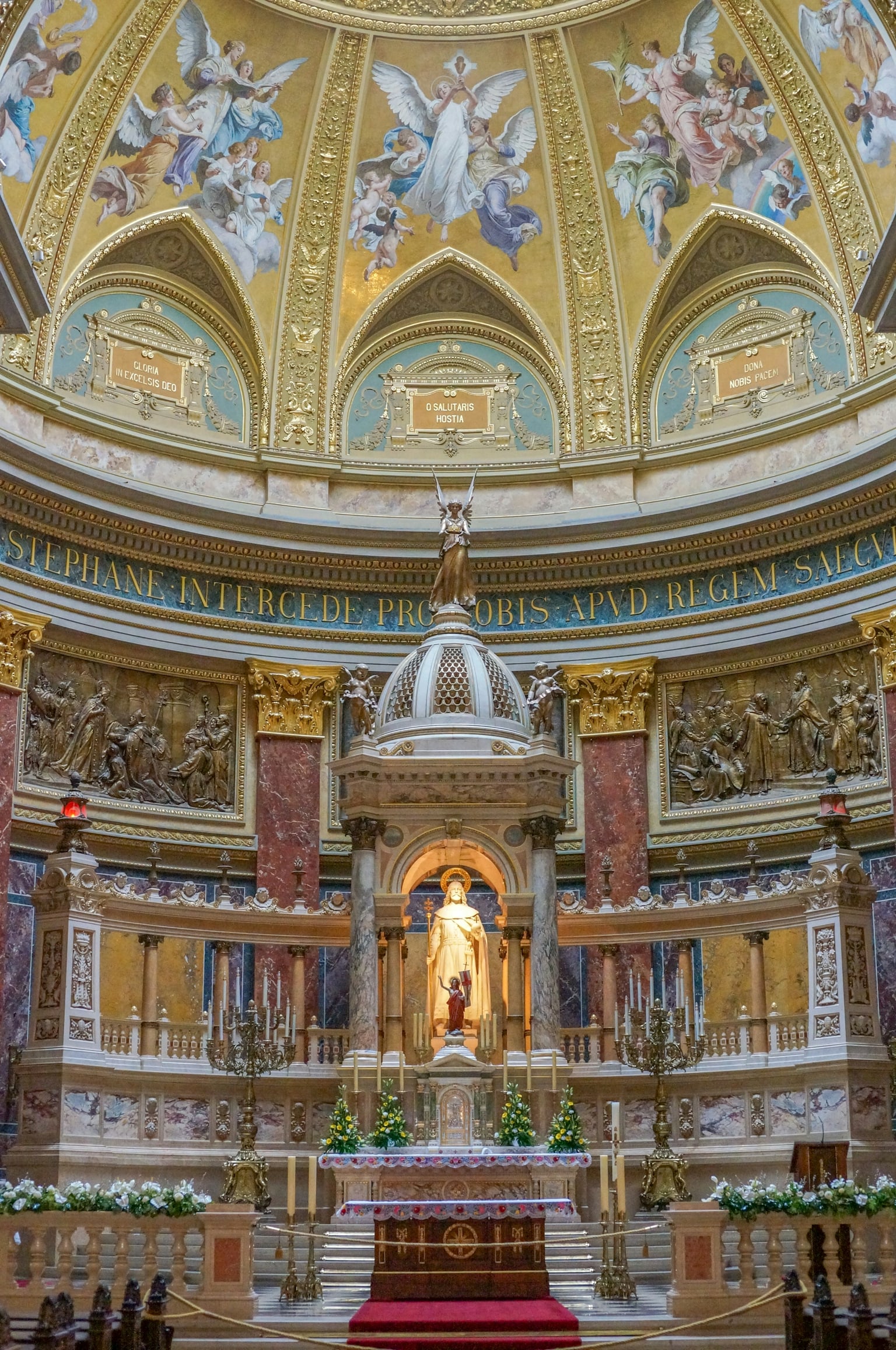 Ornate Catholic altar beneath a painted dome