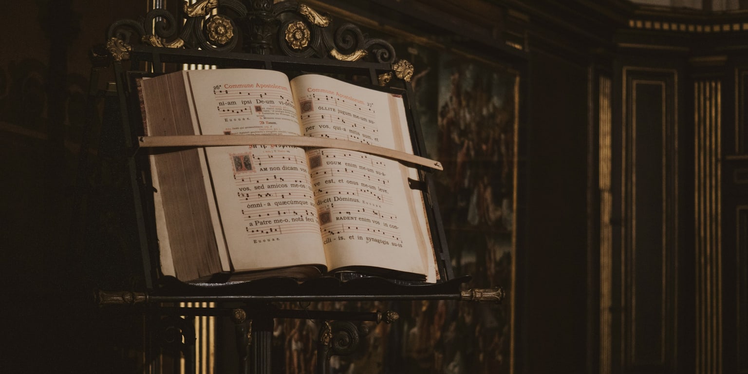 Traditional chant book open on an ornate stand
