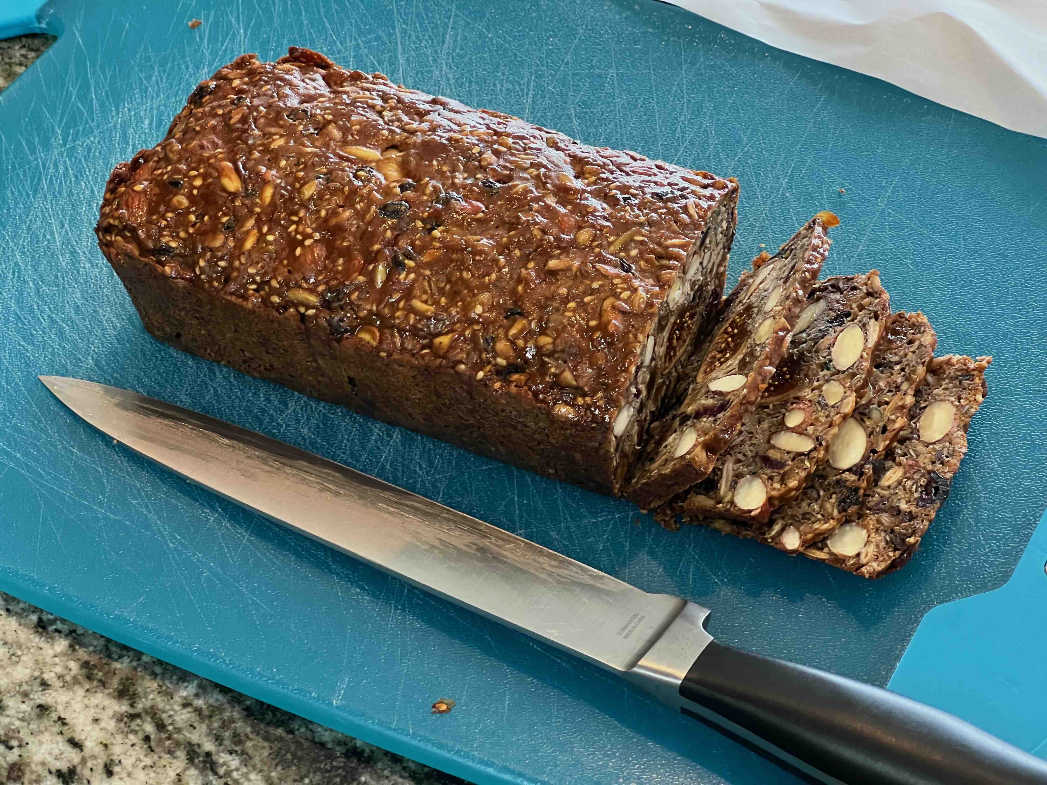 A sliced loaf of Coastal Crisps on a blue cutting board