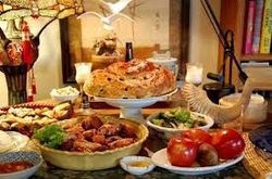 A delicious homemade meal with cake and various dishes on a table.
