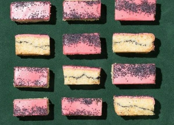 Close-up of pink and yellow rectangular candies arranged in rows.