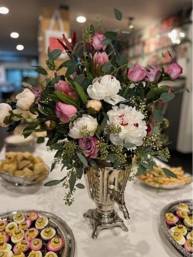 Floral arrangement centerpiece on decorated table.