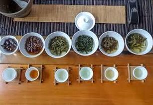 A tea tasting setup with various teas and condiments.