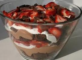Layered chocolate and strawberry dessert in a glass bowl.