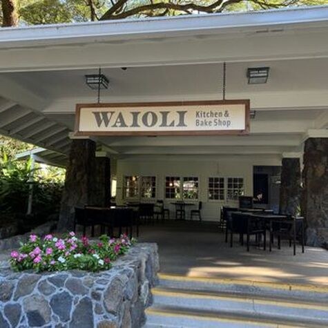 Entrance to Waioli Huiia Church with welcoming flowers and seating area.