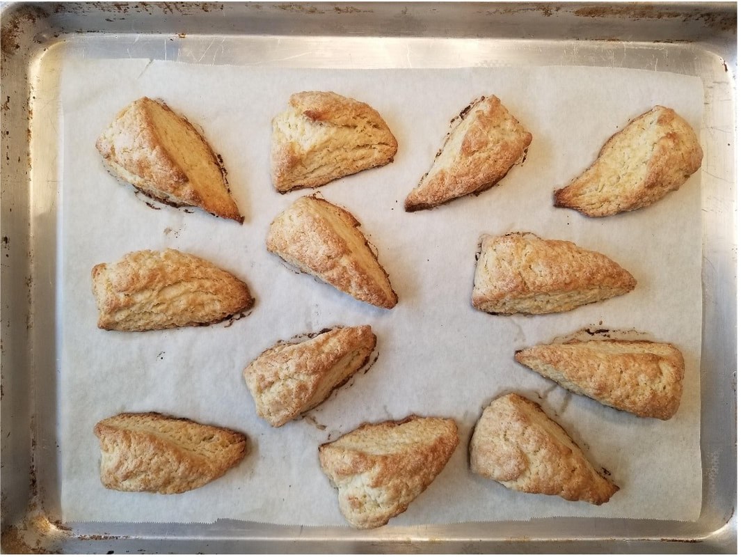 Freshly baked turnover pastries arranged on parchment paper.