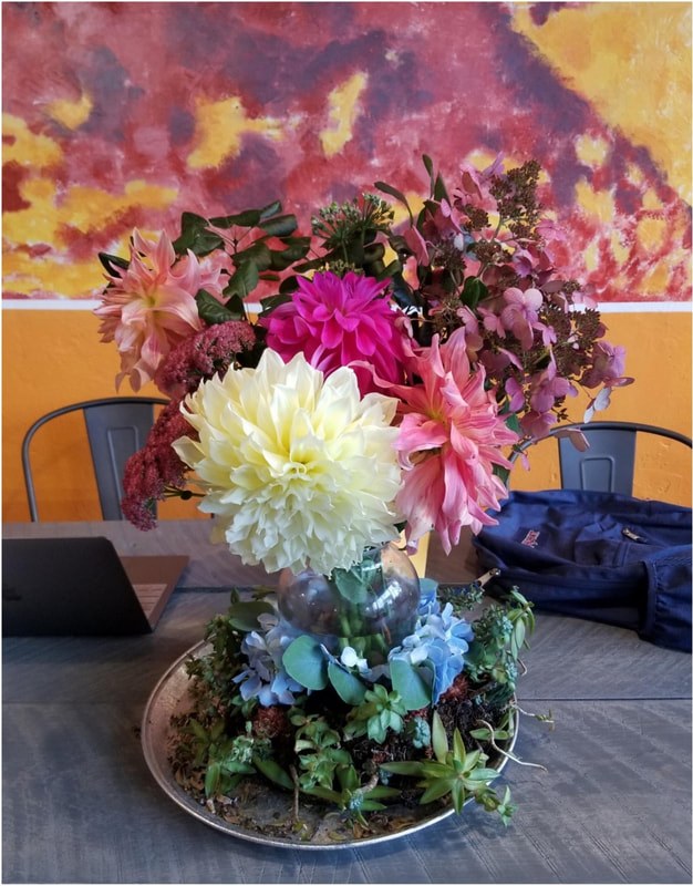 A vibrant floral arrangement with colorful flowers on a table.