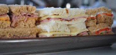 Close-up of a ham and cheese sandwich with toasted bread.