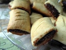 Close-up of homemade fig-filled pastries on a plate.