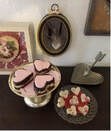 Delicious heart and bird-shaped cookies on elegant plates.