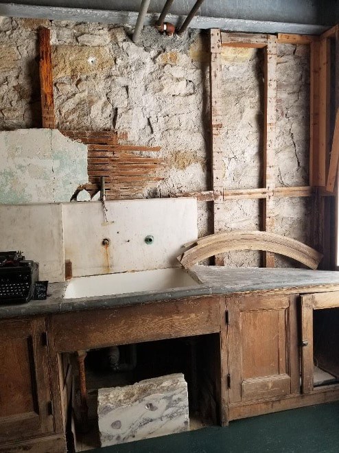 Old workshop with rustic tools and wooden workbench.