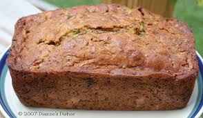 A freshly baked loaf of zucchini bread with a golden-brown crust.