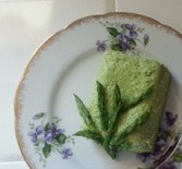 Green asparagus mousse on a floral plate.