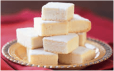 Stack of white fudge squares on a plate.