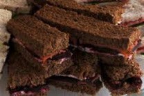 Stack of chocolate sandwiches with a red filling.