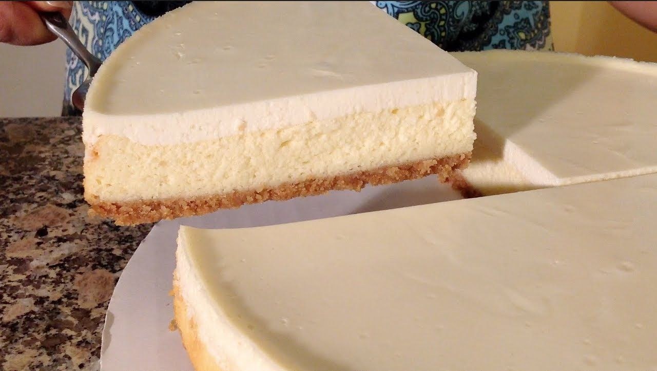 Close-up of a creamy cheesecake with a smooth top layer.