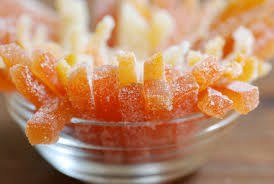 Close-up of frosted orange candy coated with sugar crystals.