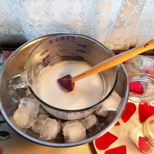 Mixing ingredients for a creamy dessert in a double boiler setup.