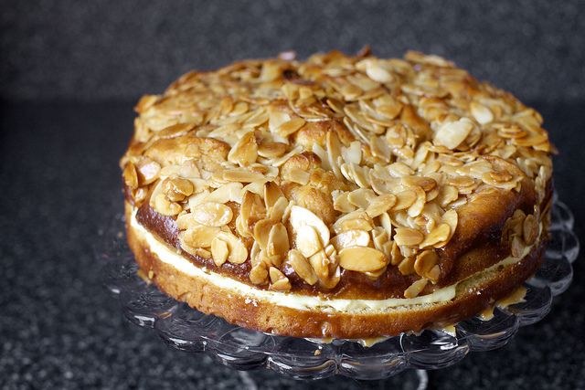 A layered almond cake with sliced almonds on top.