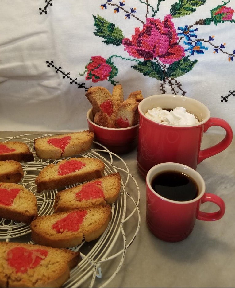 Freshly baked heart-shaped cookies with coffee and marshmallows.
