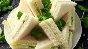 Fresh cucumber sandwiches with green garnish.