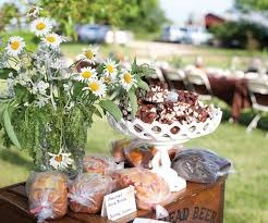 Outdoor market stall with flowers and baked goods.