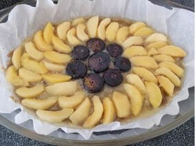 A tart topped with sliced apples and figs.