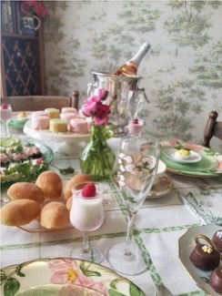 Elegant table setting with desserts and flowers.