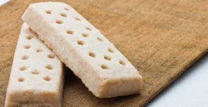 Shortbread cookies arranged on a brown cloth.
