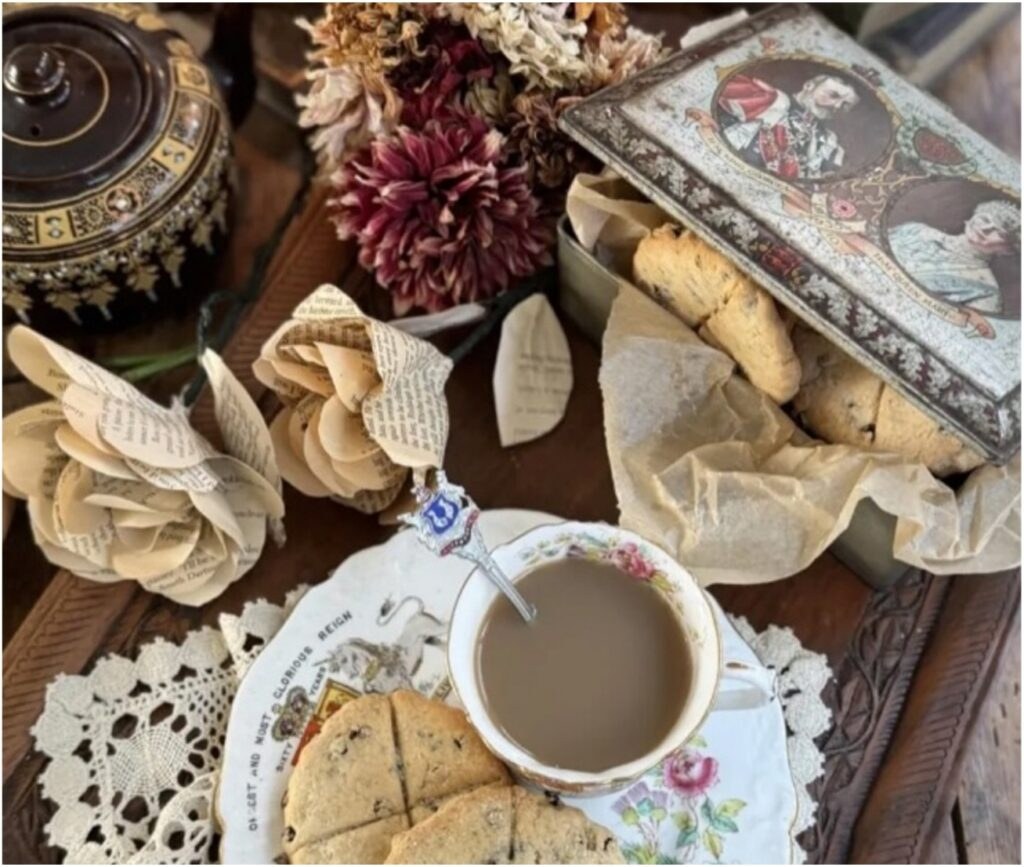 A cozy cup of coffee with pastries and dried flowers on a decorative table.