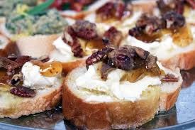 Sliced bread topped with creamy cheese and caramelized onions.