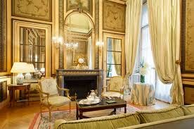 Elegant classic living room with ornate decorations and large windows.
