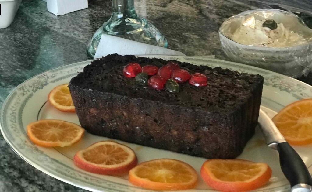 Fruitcake with citrus slices on plate.