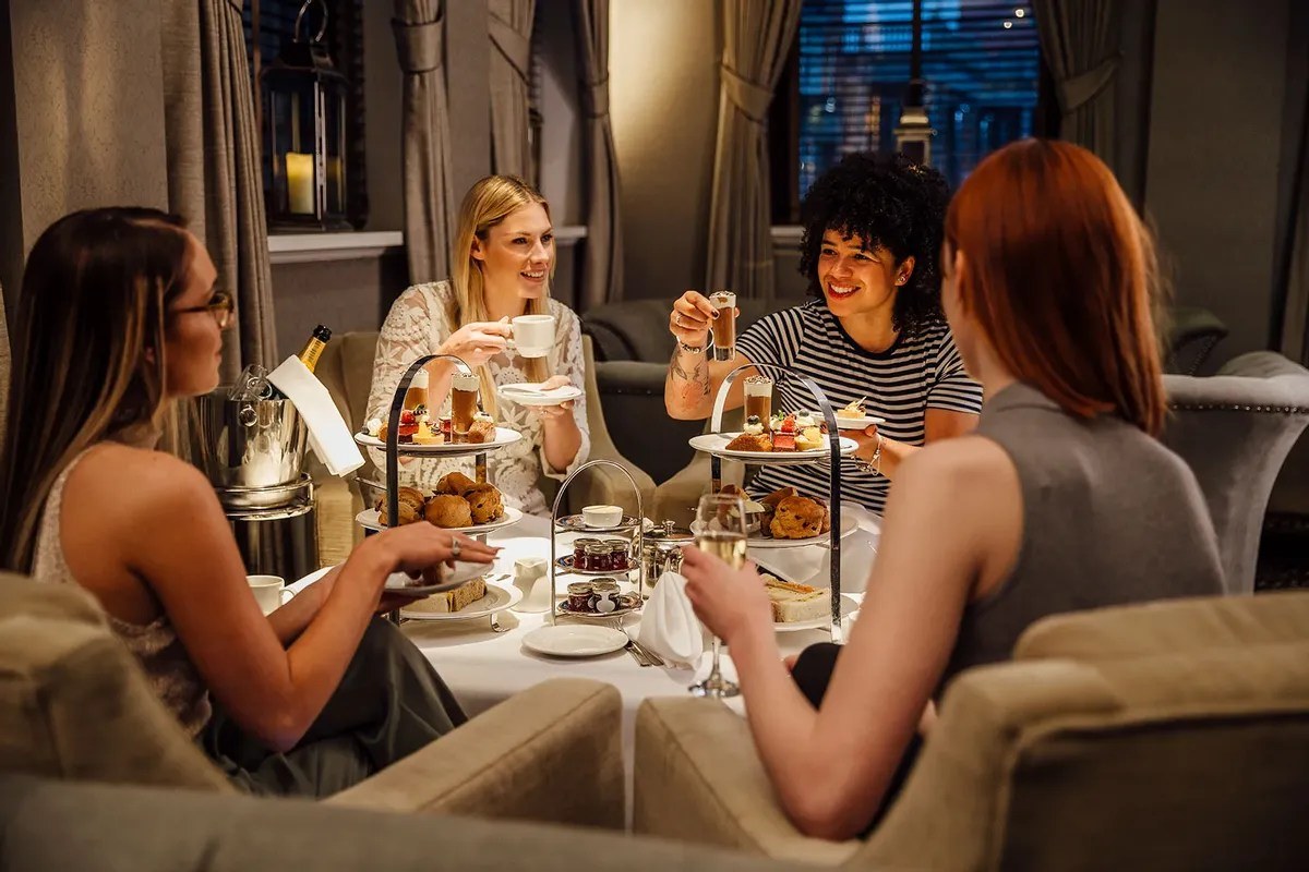 Friends enjoying a cheerful dinner toast in an elegant setting.