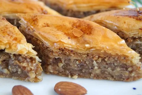 Close-up of traditional baklava with nuts and syrup.