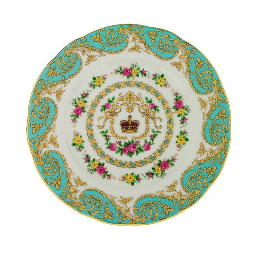 Ornate decorative plate with gold and floral designs on turquoise and white.