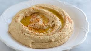 Creamy hummus drizzled with olive oil and sprinkled with paprika.