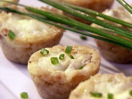 Close-up of savory steamed dumplings garnished with chopped chives.
