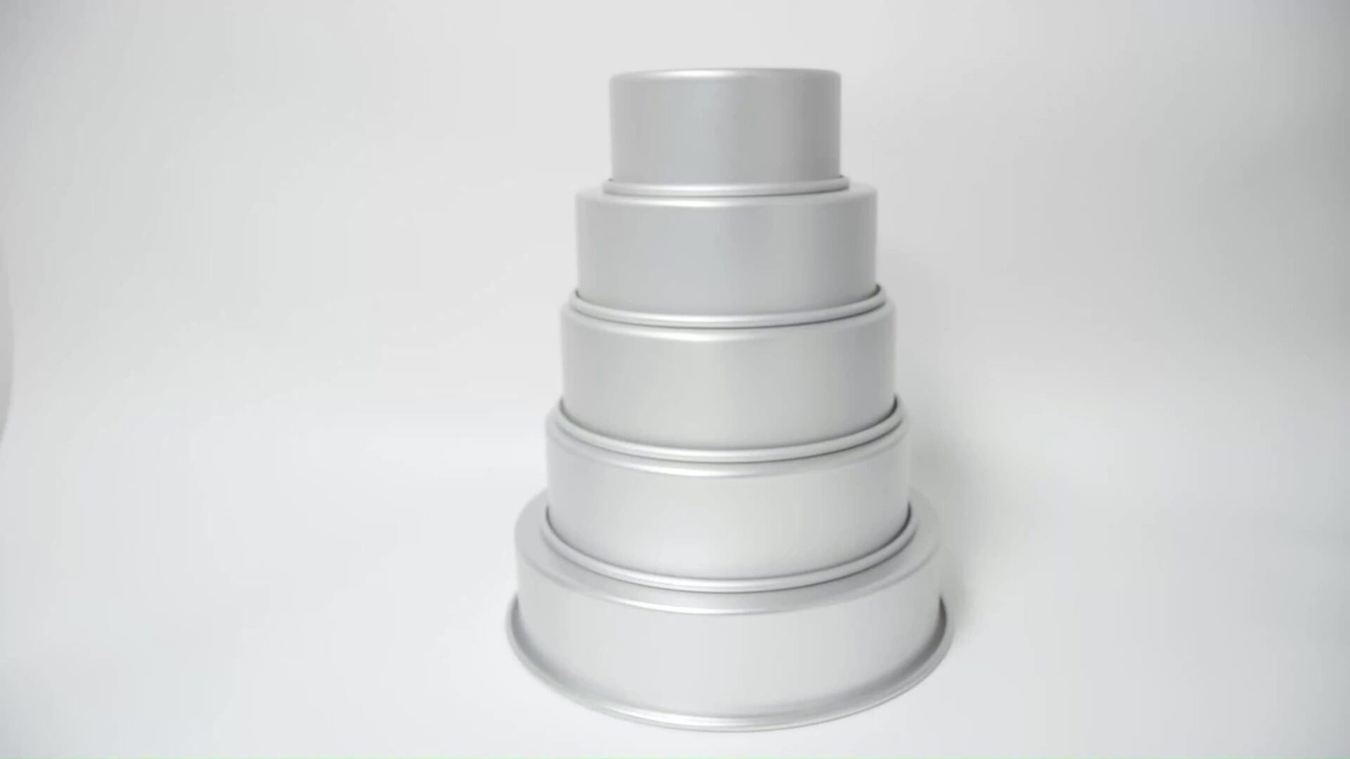 Stacked silver round cake pans in various sizes.