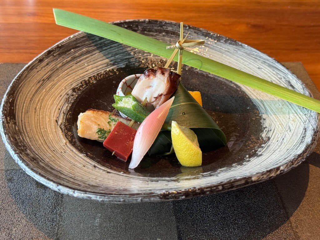 Artistic Japanese kaiseki dish with assorted seasonal delicacies.