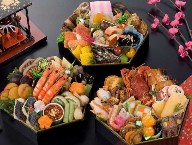 Elegant Japanese osechi-ryori meal with assorted traditional dishes in lacquer boxes.