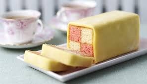 A sliced Battenberg cake with pink and yellow squares.