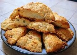 Freshly baked scones with a golden crust on a plate.